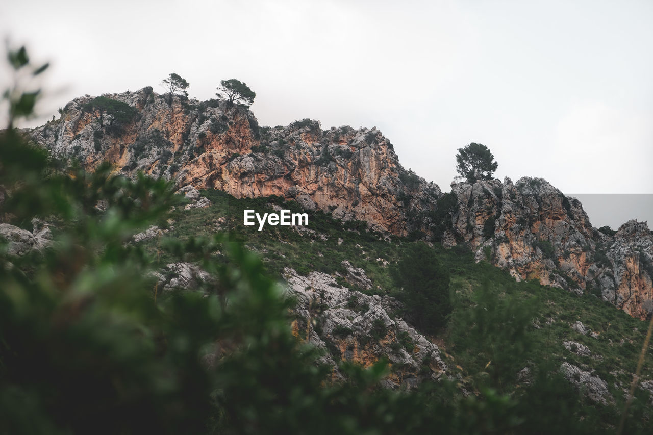 Low angle view of rock formations against sky