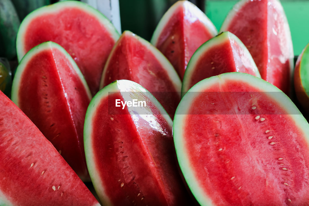 The fresh red watermelon from an indonesian farmer, which is split into two parts to sell.