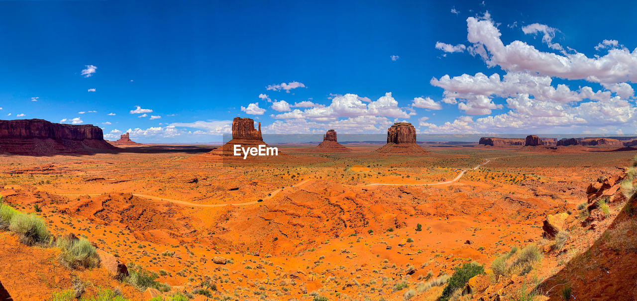 PANORAMIC VIEW OF ROCKS ON LANDSCAPE AGAINST BLUE SKY