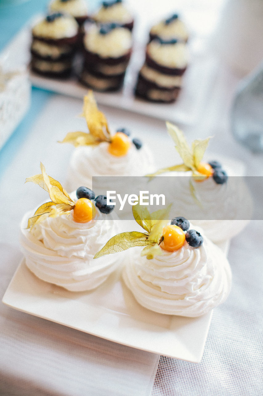 White pavlova cakes with blueberry and fruits