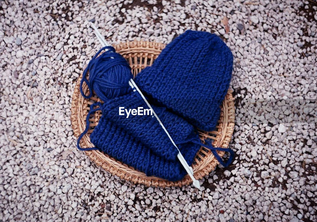 High angle view of blue knit hat in basket