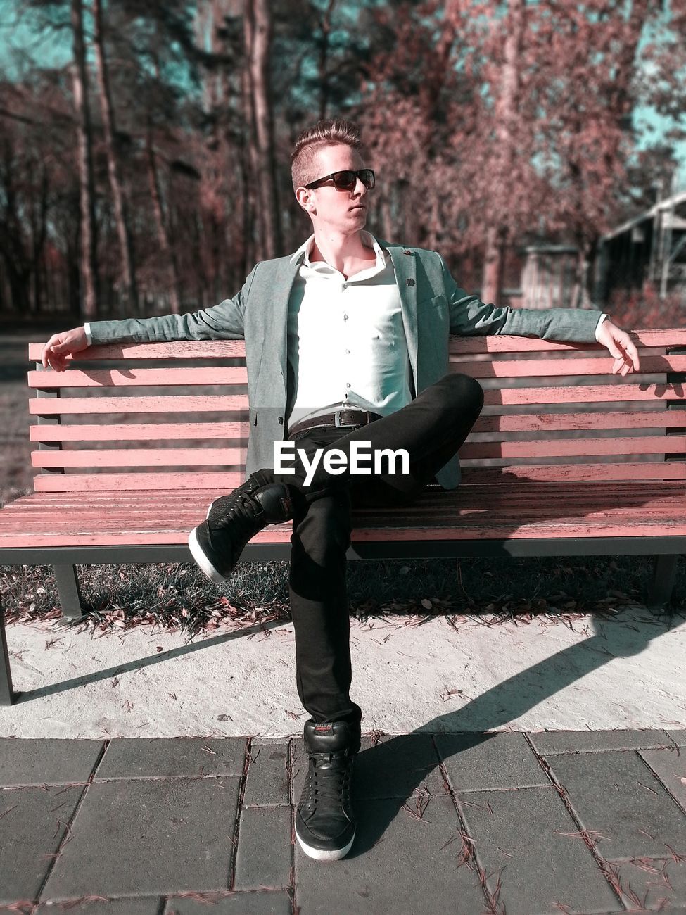 Front View Of Man Sitting On Bench At Park Id 76907253