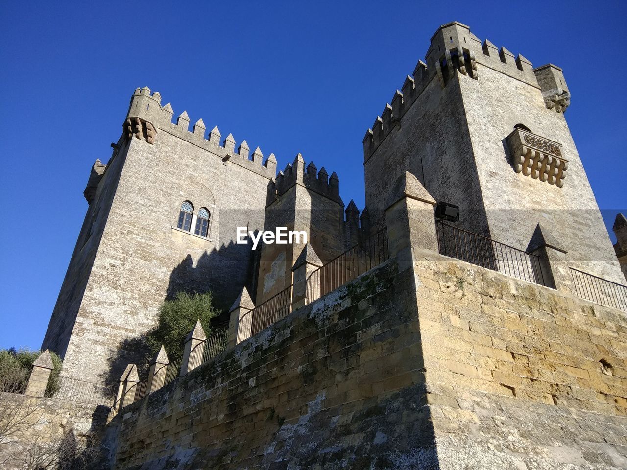 LOW ANGLE VIEW OF FORT AGAINST BLUE SKY