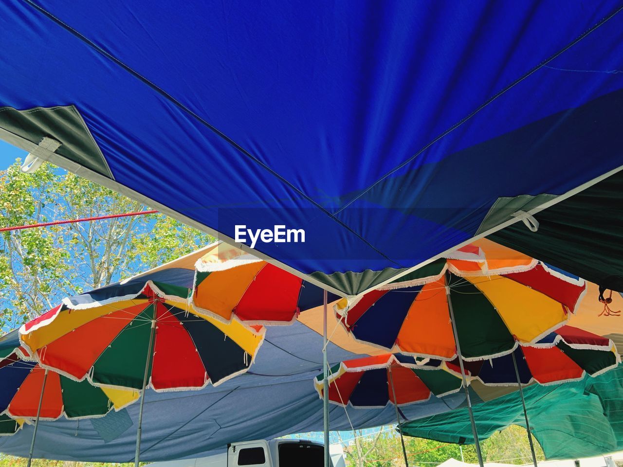 LOW ANGLE VIEW OF TENT HANGING AGAINST SKY