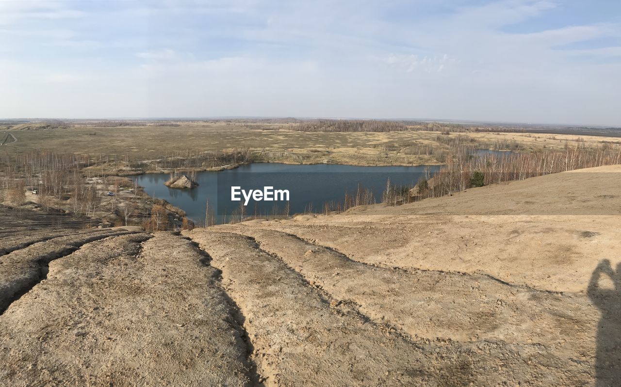 Panoramic view of land against cloudy sky