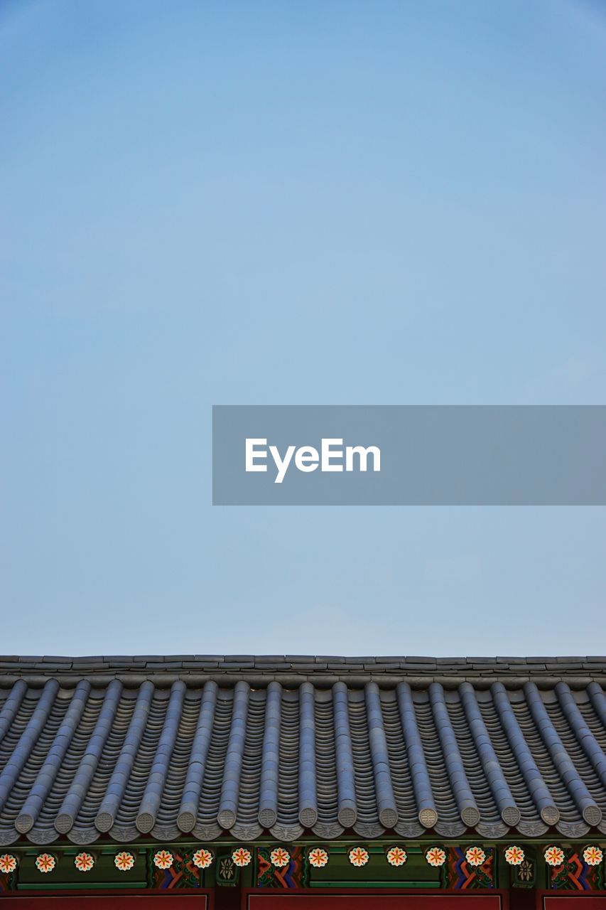 Roof of building against clear blue sky