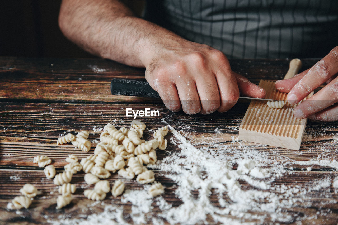Midsection of man preparing food on table