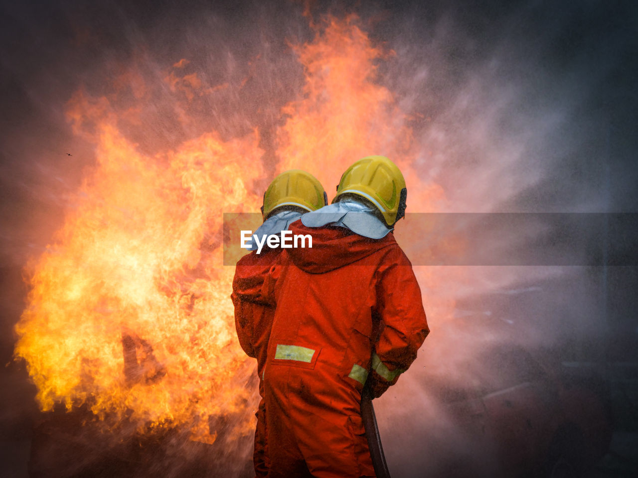 Fire fighter standing in front of explosion