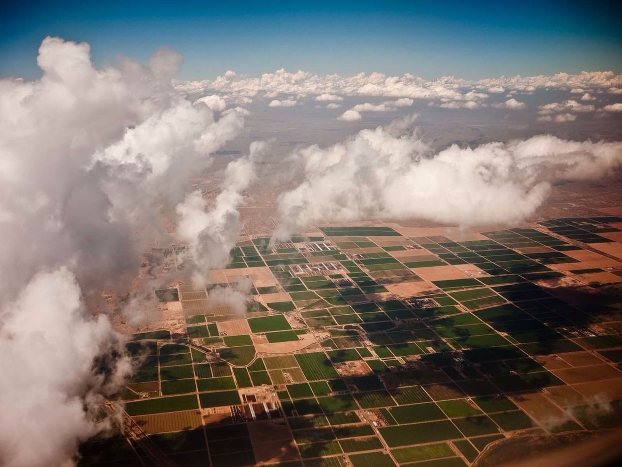 Aerial view of clouds over farms