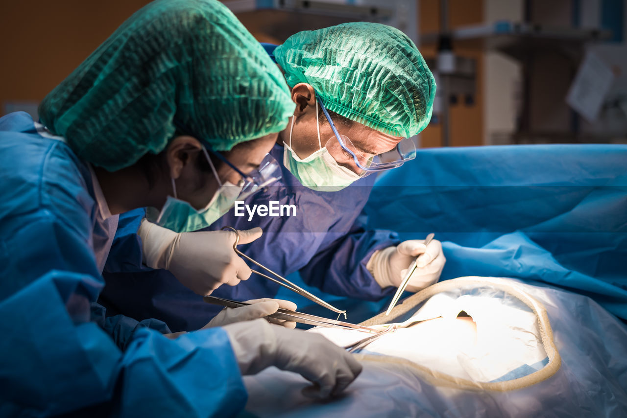 Surgeons performing surgery in operating room