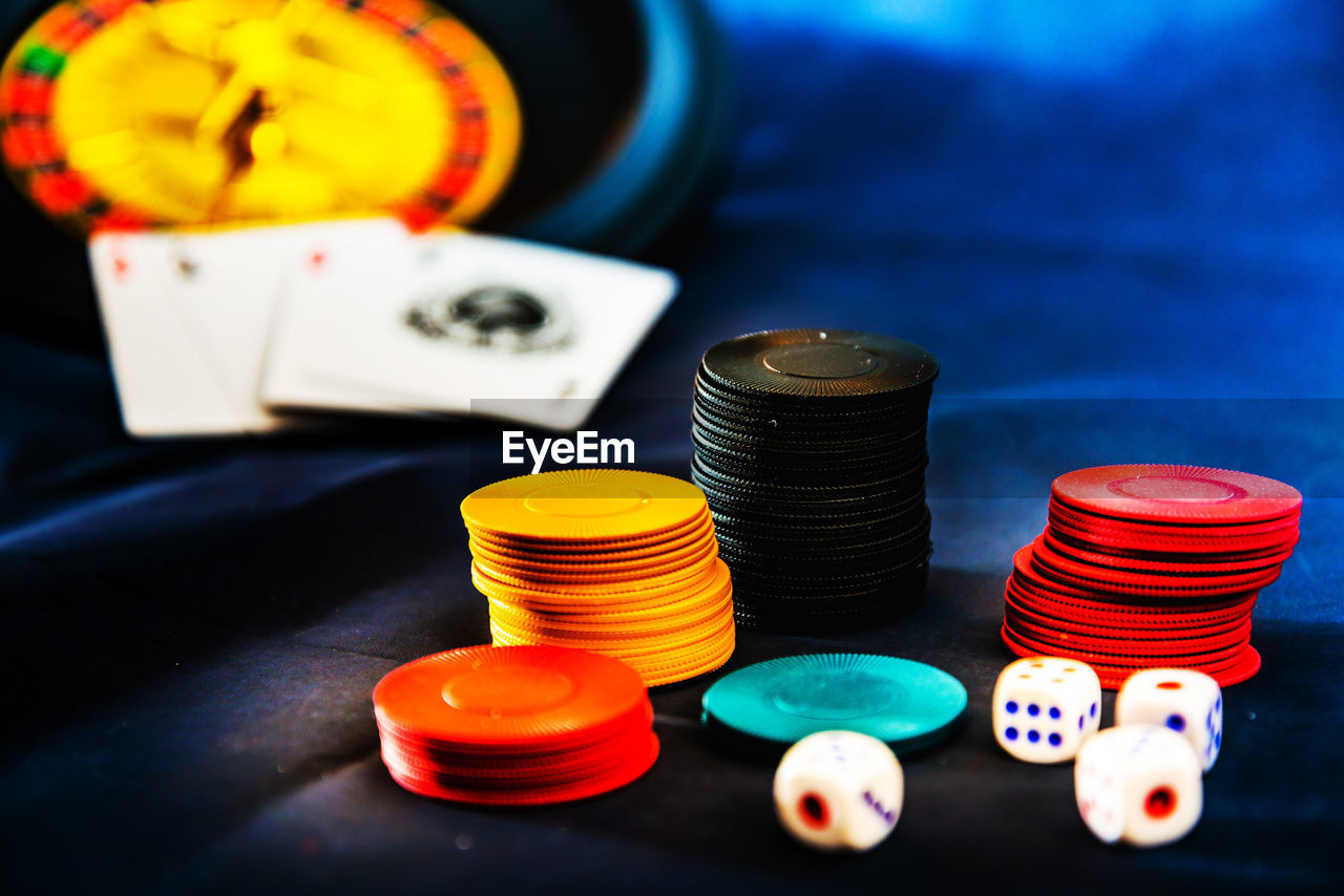 Close-up of gambling chips and dices on table