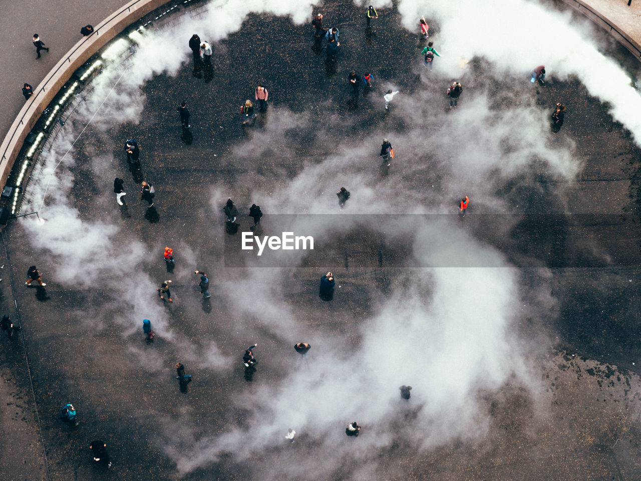 High angle view of people at town square during foggy weather