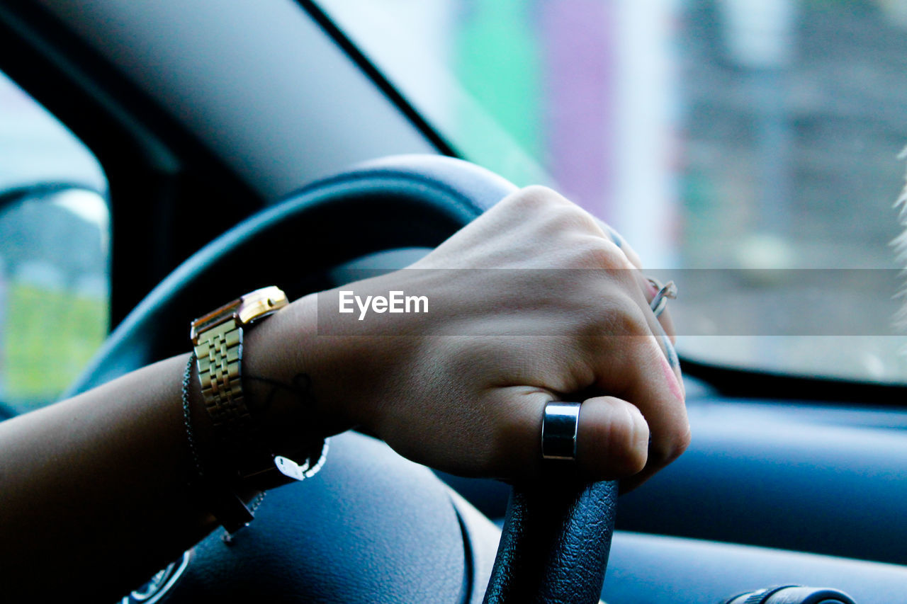 Cropped image of woman driving car