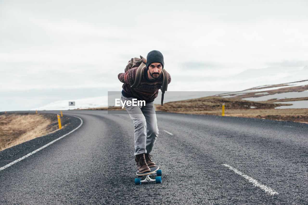 Man skateboarding on highway