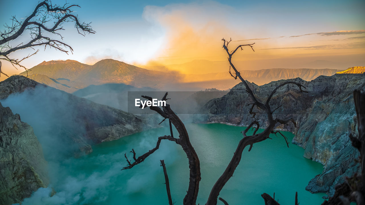 Scenic view of mountains against sky during sunrise at ijen lake crater volcano. 