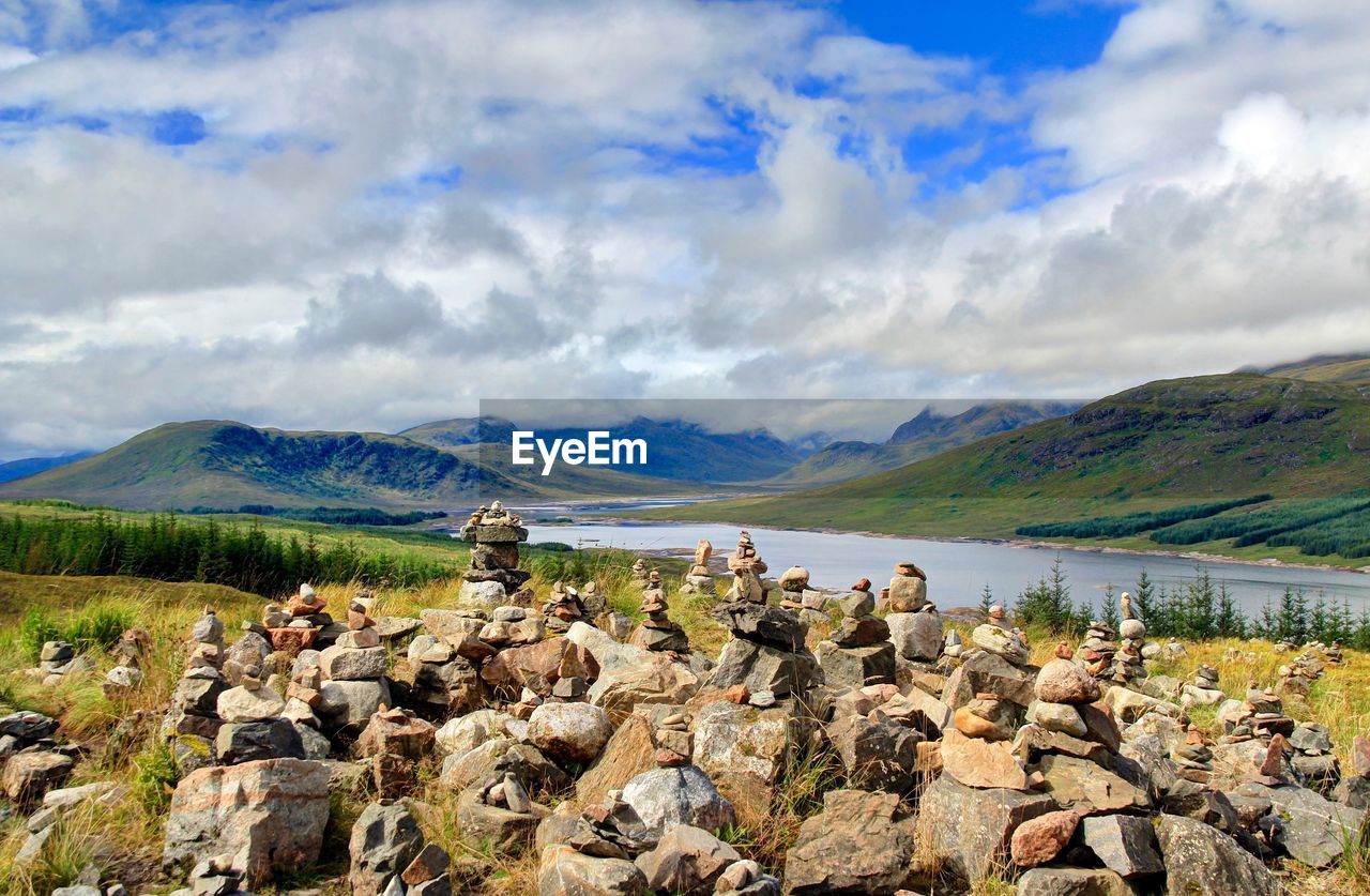 Panoramic view of rocks and lake against sky
