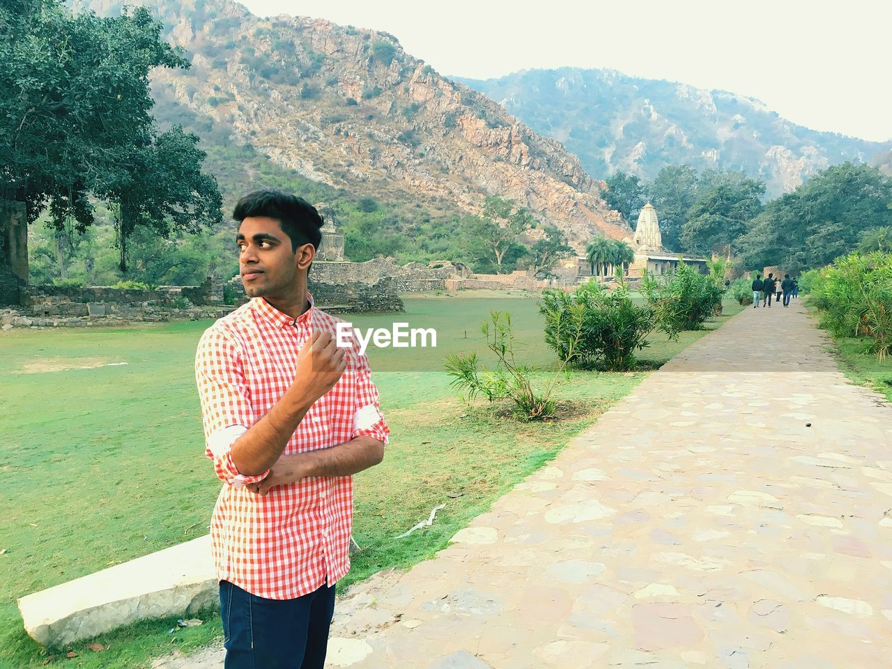 Young man standing on footpath at bhangarh fort