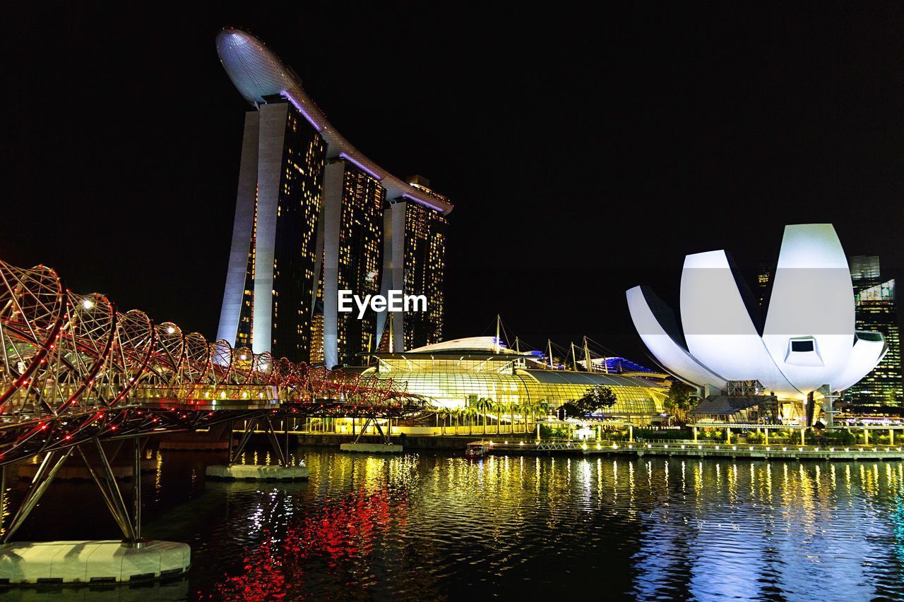 Illuminated marina bay buildings in city at night singapore