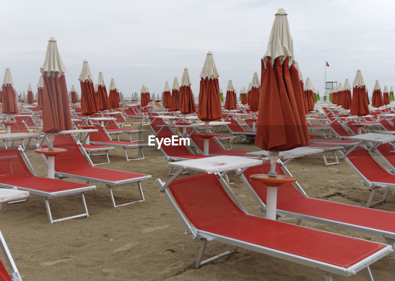 Closed canopy with sun lounger on sand 