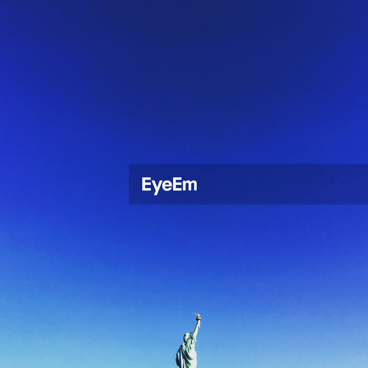 Low angle view of statue of liberty against clear blue sky