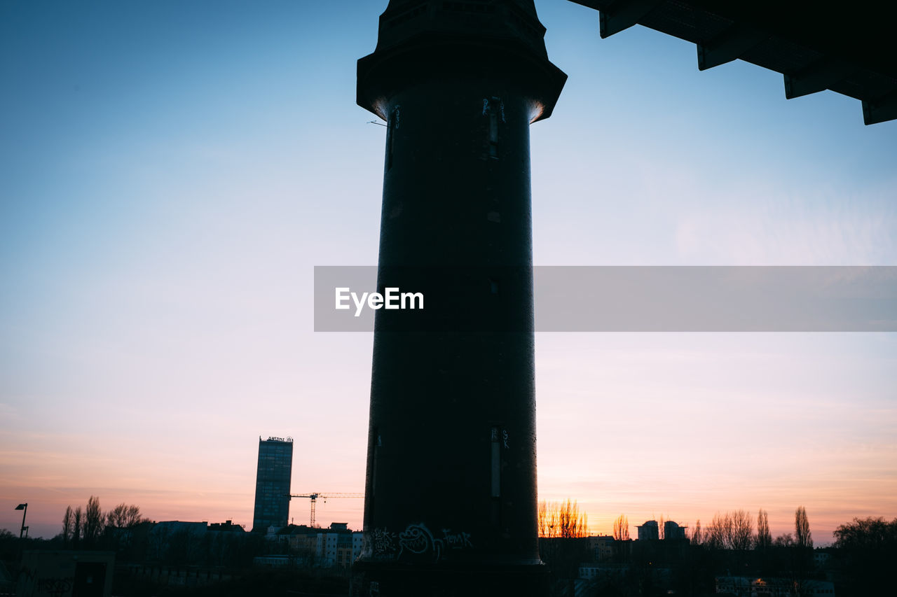 Low angle view of silhouette tower against sky during sunset