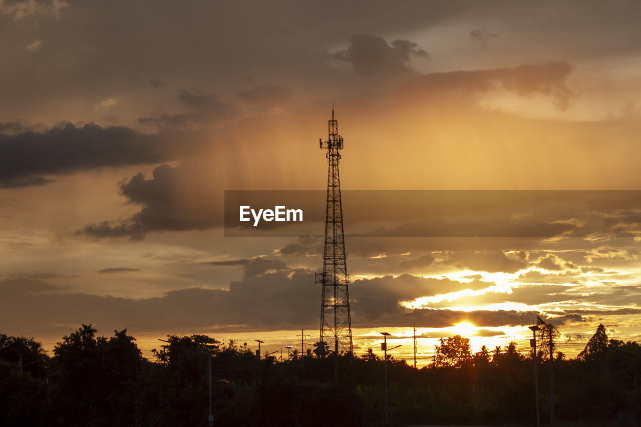 SILHOUETTE COMMUNICATIONS TOWER AGAINST SKY DURING SUNSET