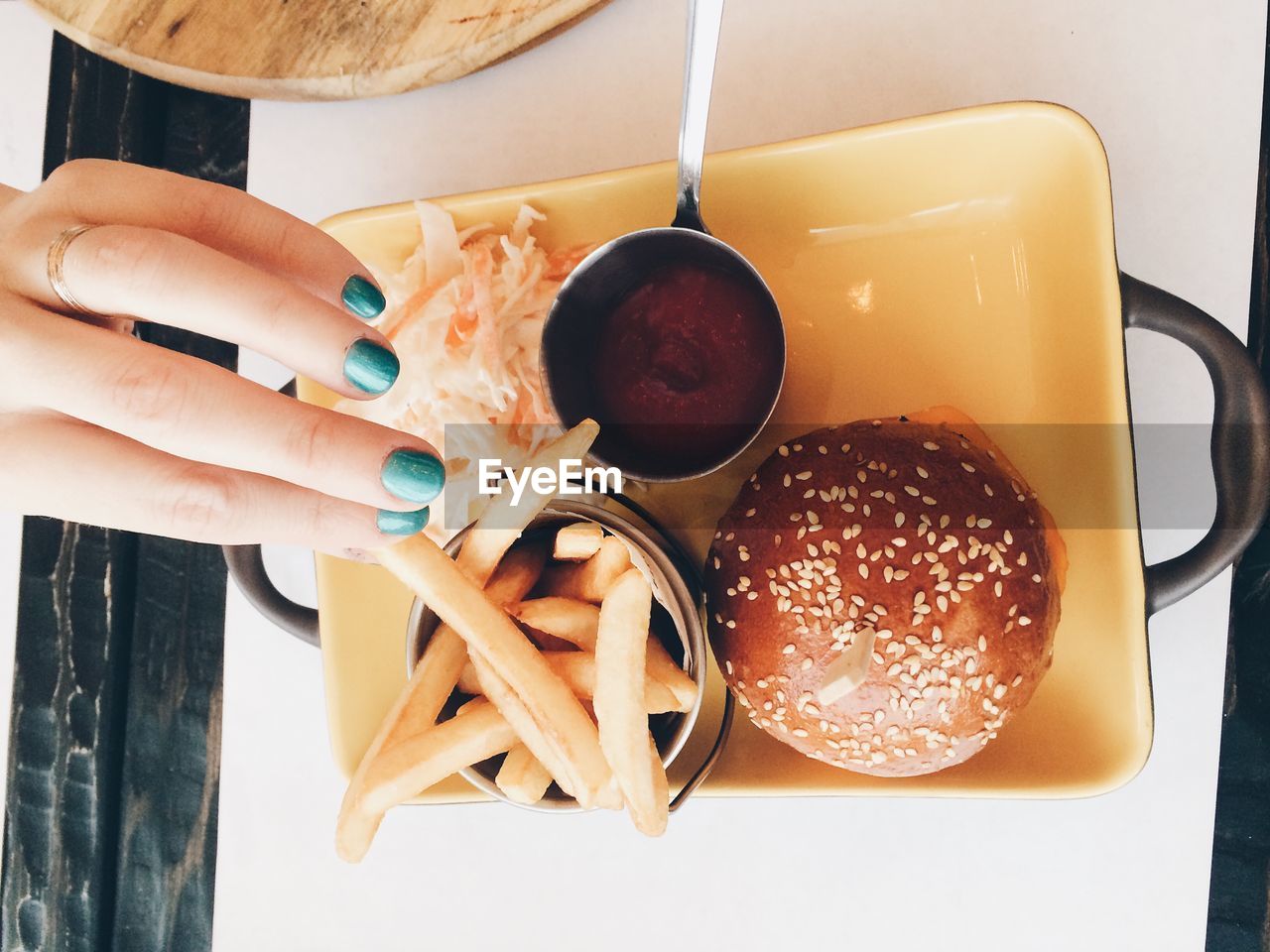 Close-up of hand and hamburger 