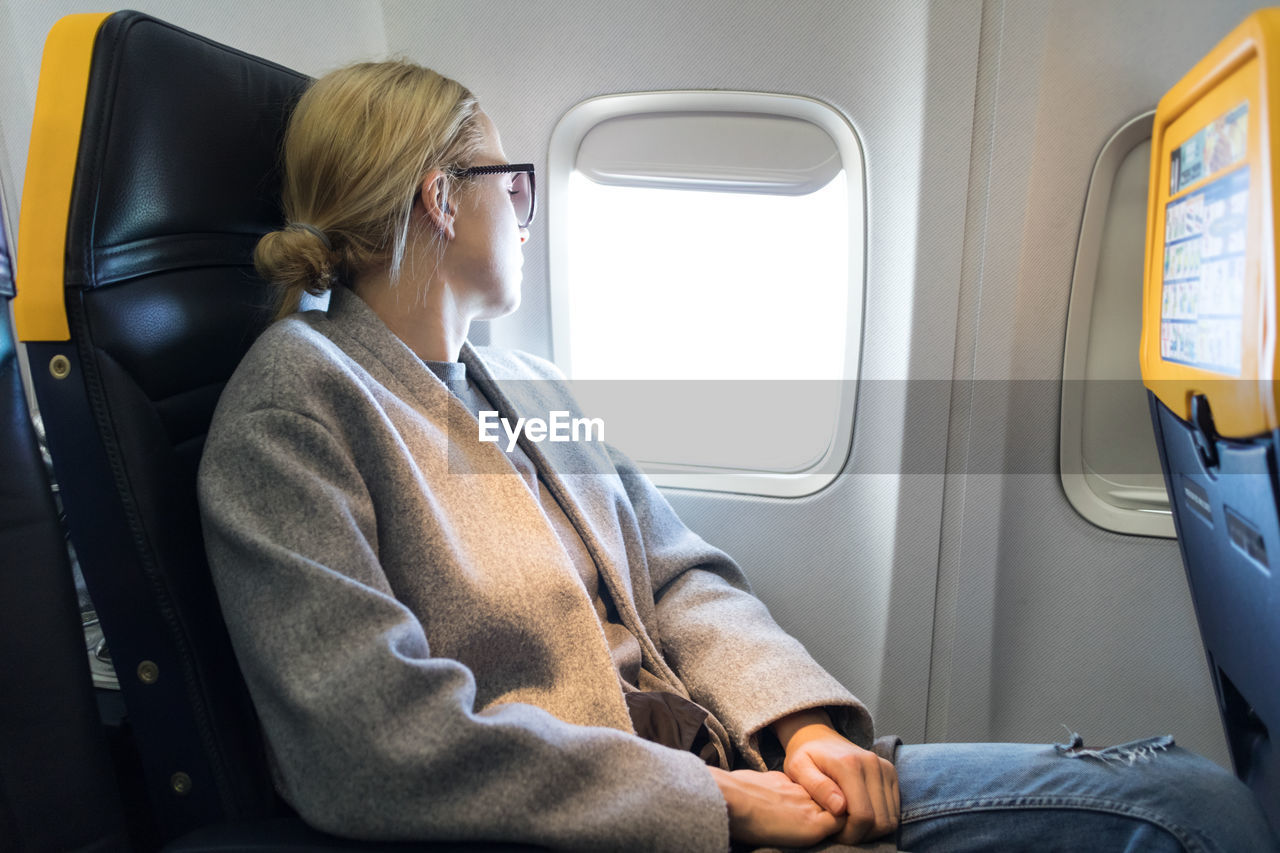 Mid adult woman sleeping in airplane