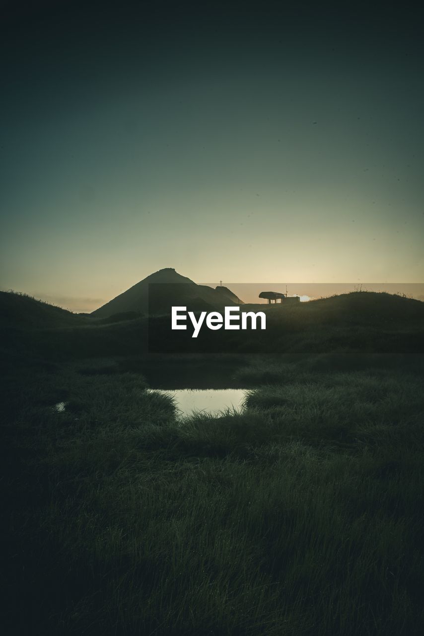 SCENIC VIEW OF LAND AGAINST SKY DURING SUNSET