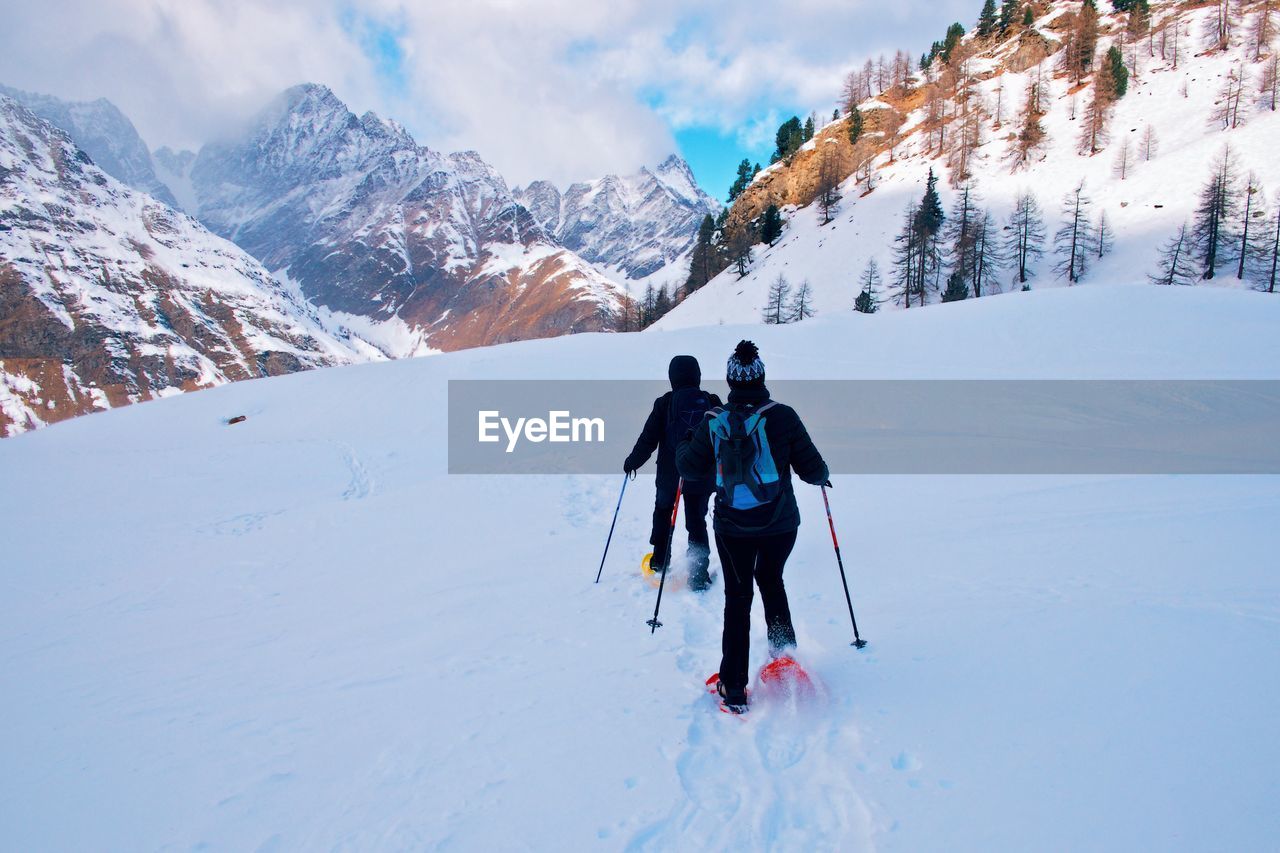 PEOPLE ON SNOW COVERED MOUNTAINS