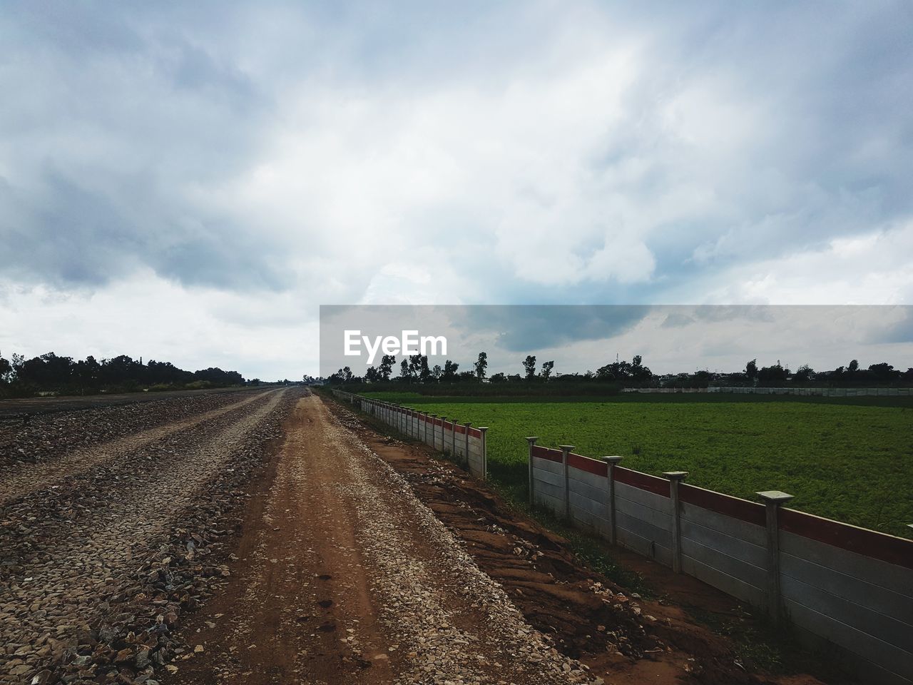 field, sky, cloud, landscape, road, rural area, environment, soil, horizon, land, nature, agriculture, rural scene, highway, transportation, plain, dirt, farm, plant, no people, transport, dirt road, vanishing point, diminishing perspective, hill, scenics - nature, infrastructure, prairie, track, the way forward, outdoors, day, food, crop, grass, food and drink, beauty in nature, tranquility, travel, non-urban scene