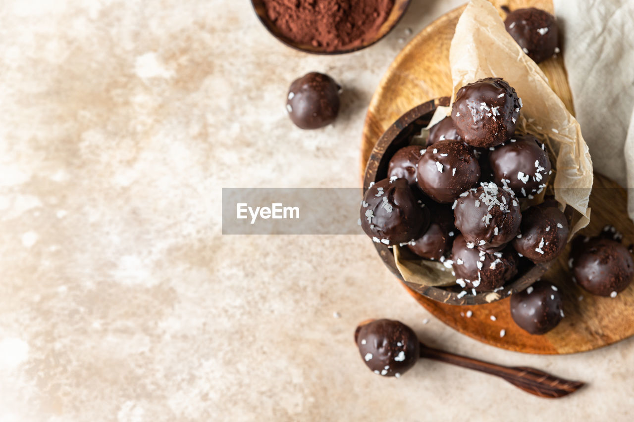 food and drink, food, produce, dessert, freshness, fruit, sweet food, indoors, healthy eating, no people, dried fruit, sweet, still life, breakfast, chocolate, plant, dish, studio shot, dried food, brown, close-up, high angle view, nut - food, wood, nut, raisin, wellbeing