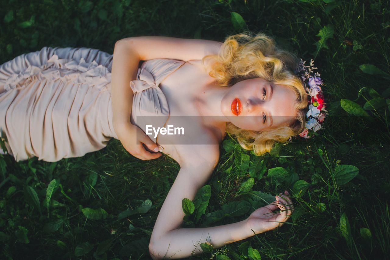 Young woman lying in grass
