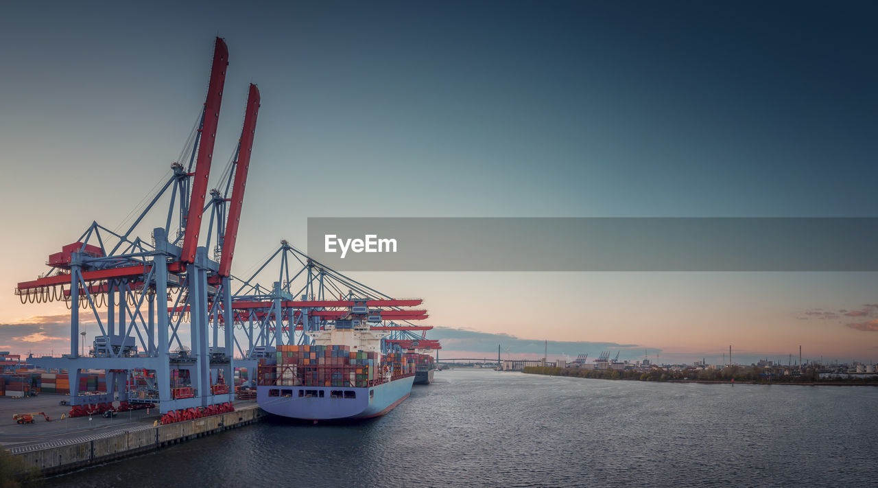 Commercial dock by sea against sky