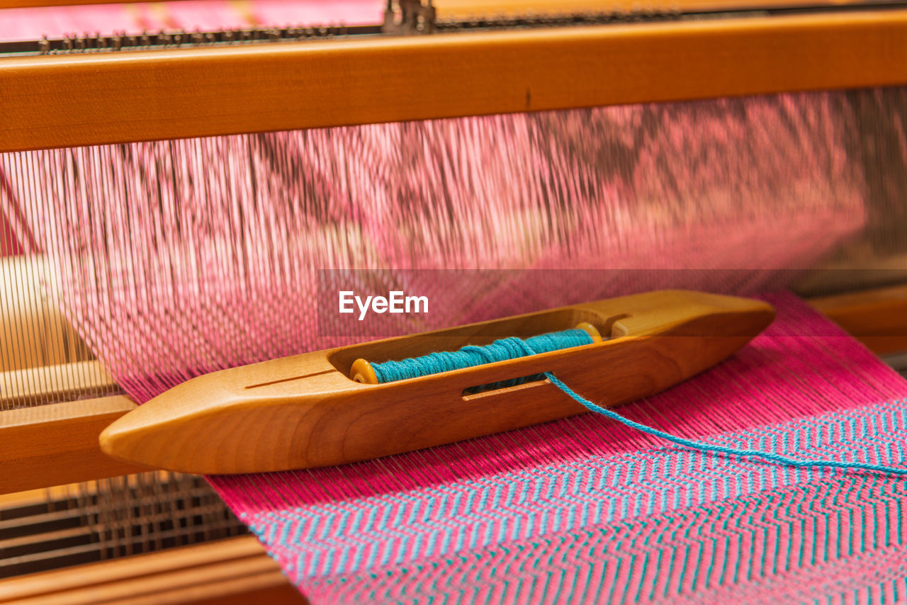 High angle view of thread on weaving machinery