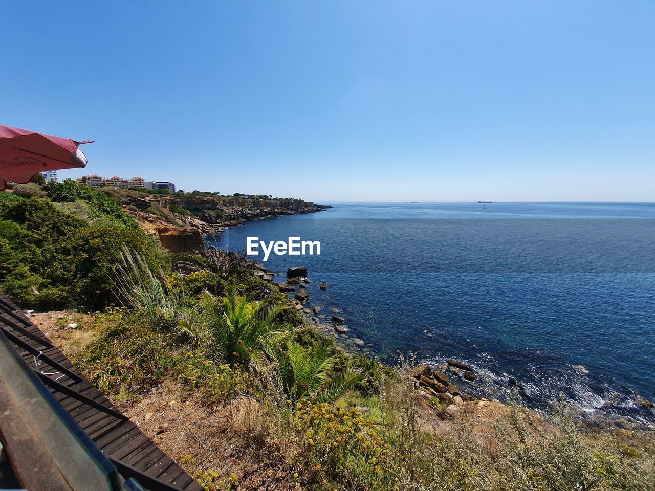 Scenic view of sea against clear blue sky