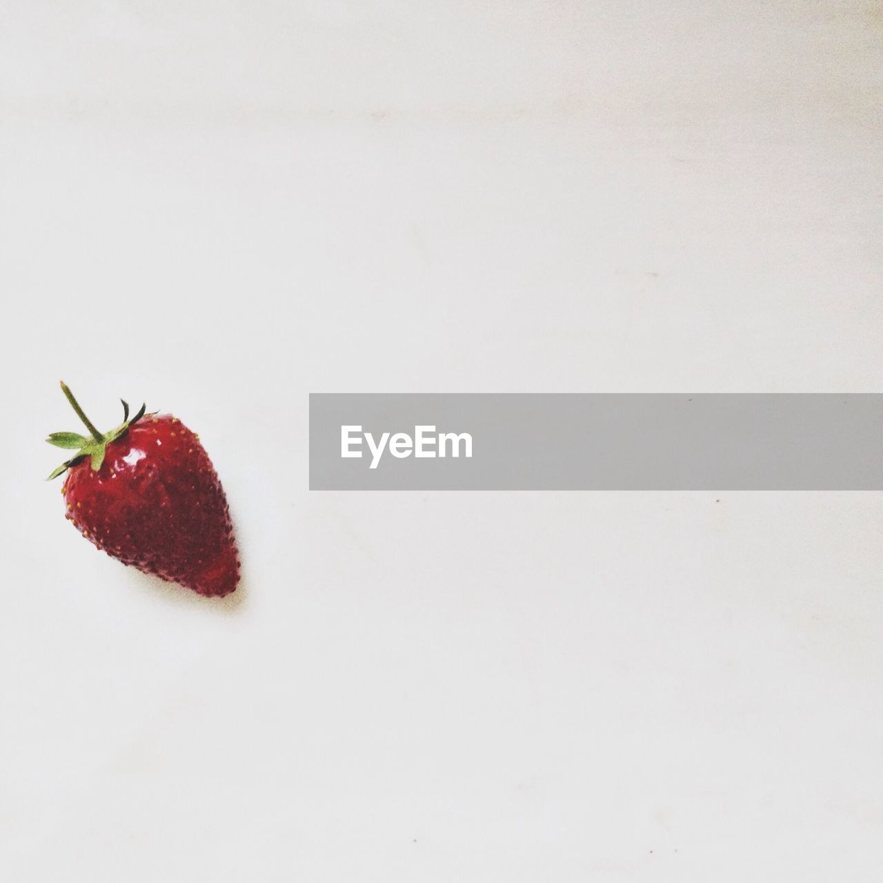 Close-up of a strawberry over white background