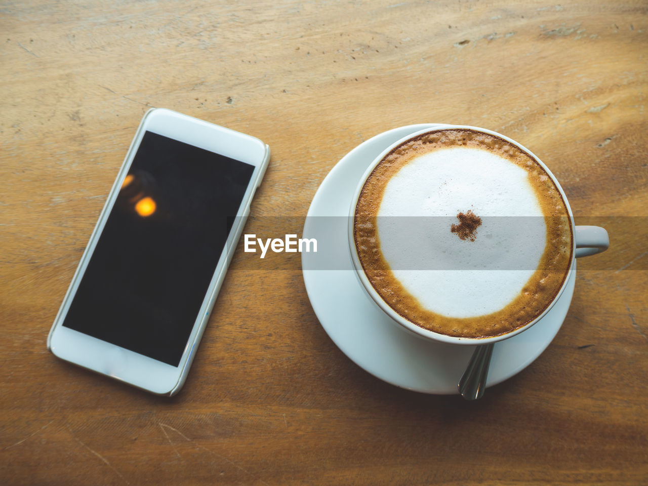 HIGH ANGLE VIEW OF COFFEE CUP ON TABLE