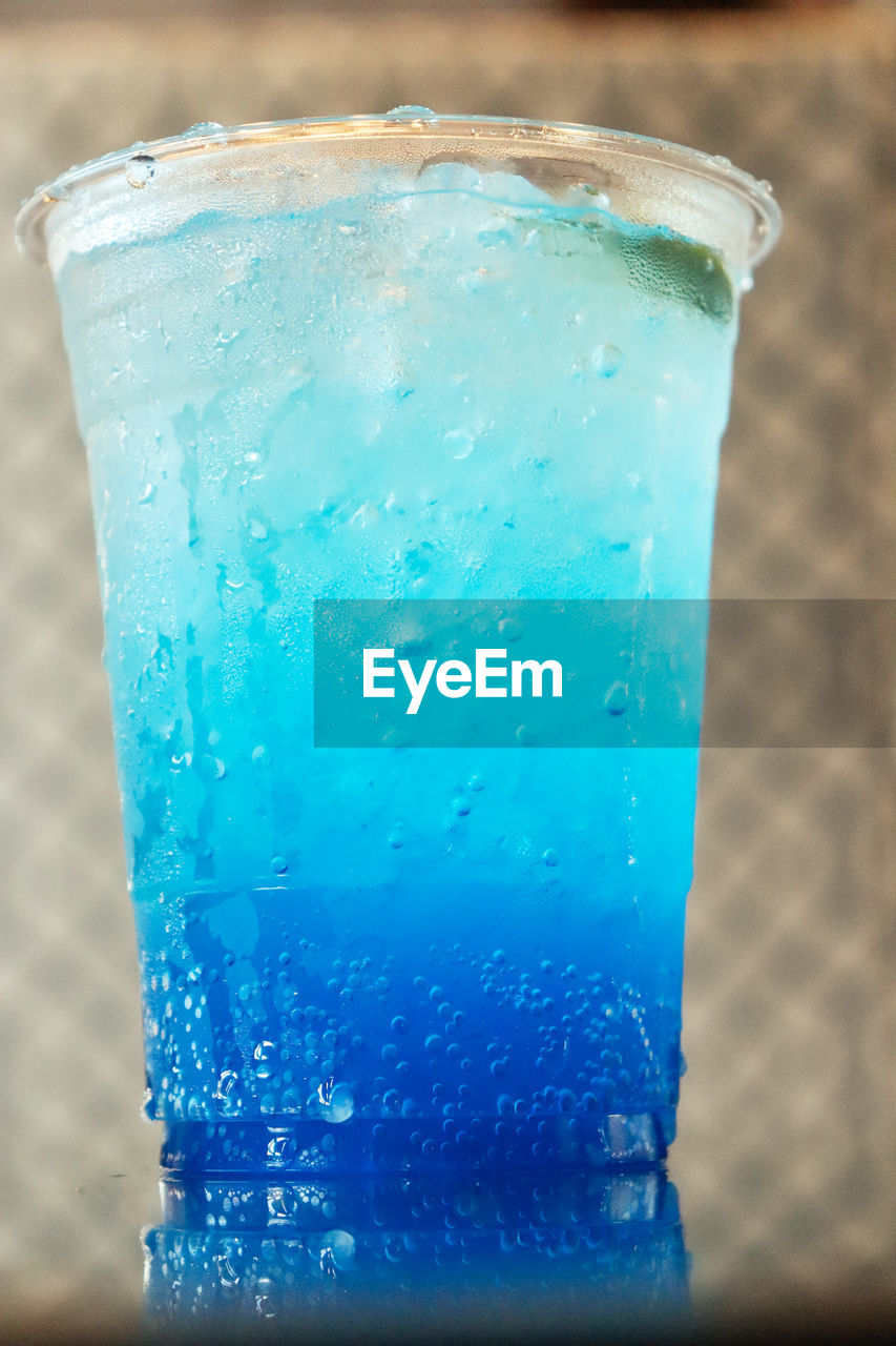 soft drink, refreshment, blue, drink, food and drink, drinking glass, cold temperature, household equipment, glass, aqua, close-up, frozen, water, no people, ice, ice cube, freshness, alcohol, nature, wet, turquoise, bubble, indoors, focus on foreground, soda, food