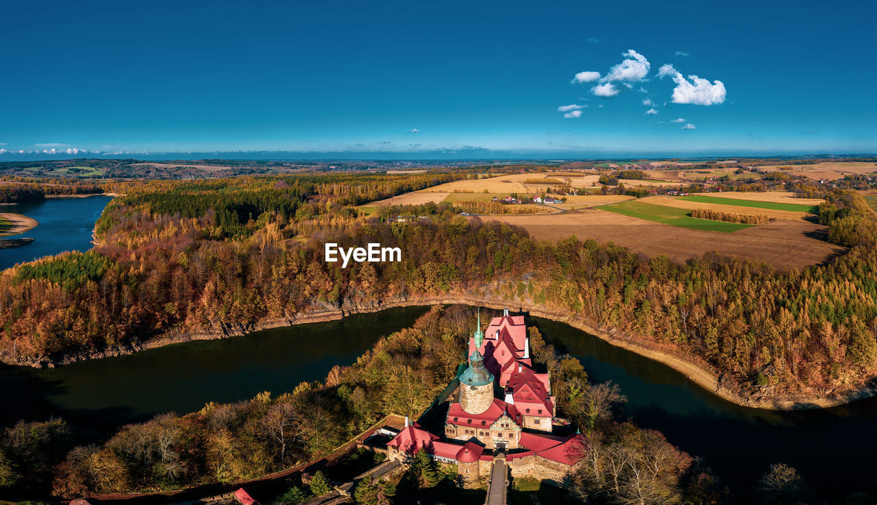 Aerial view of building by river against sky