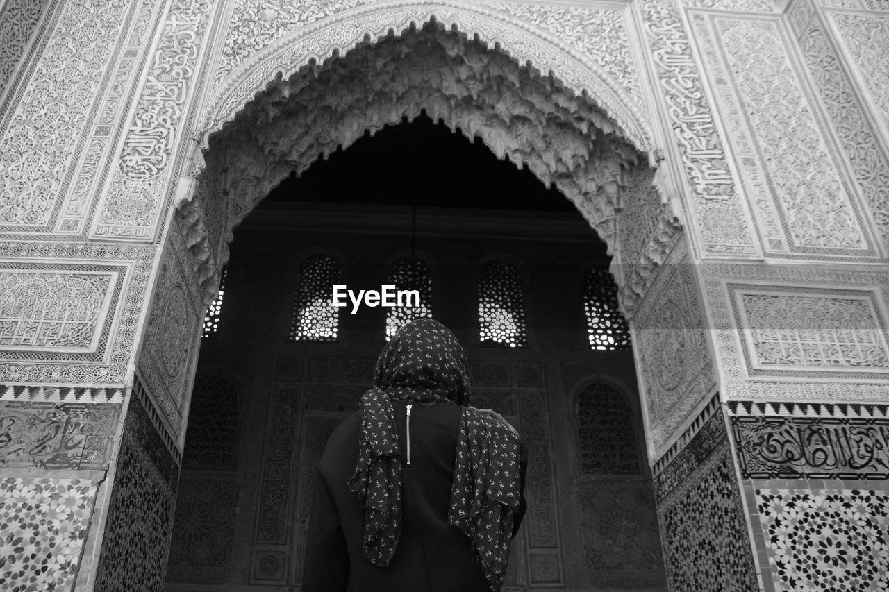 Low angle rear view of woman at mosque
