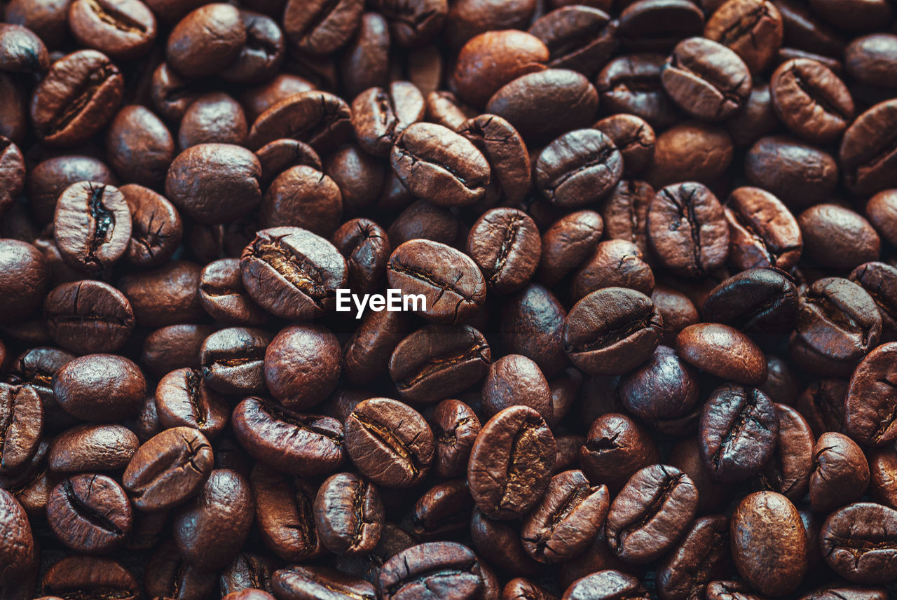 Coffee beans background, dark and light brown roasted coffee-beans closeup