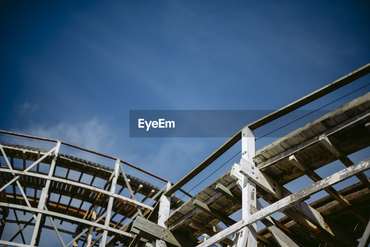 Low angle view of wooden structure against blue sky