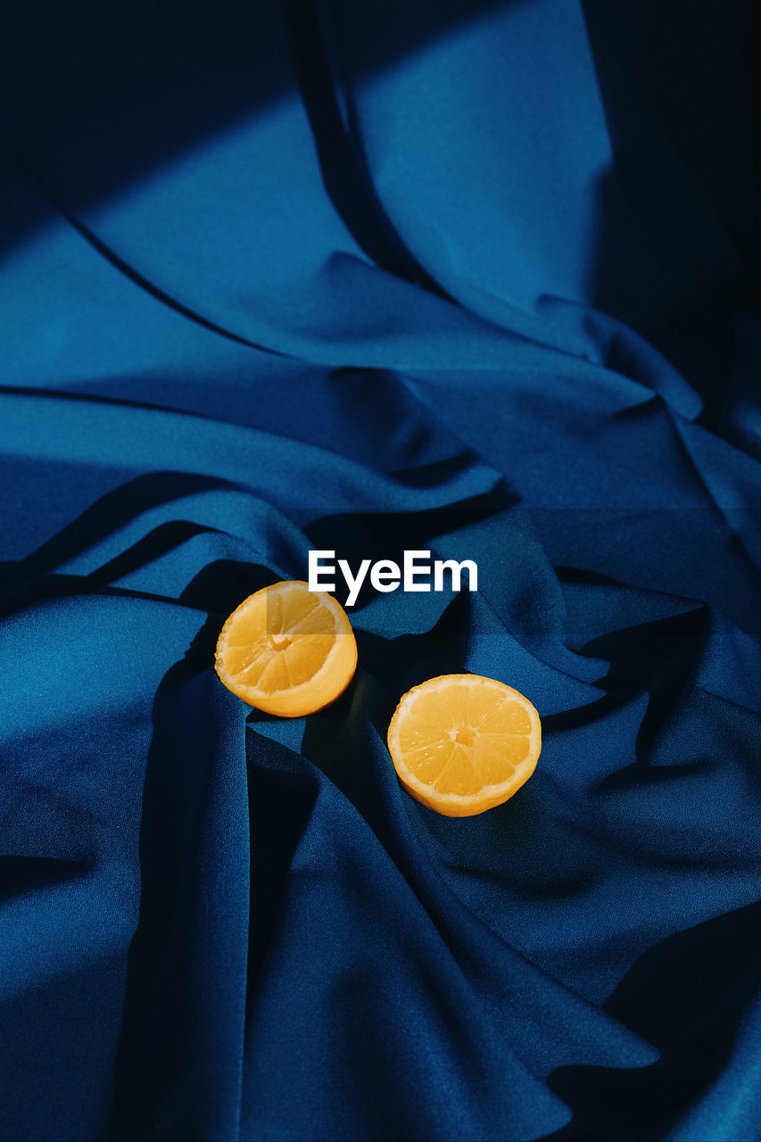 High angle view of lemons on blue surface