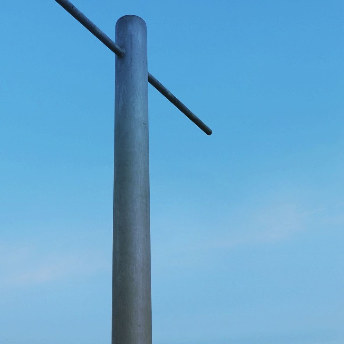 Low angle view of pole on jetty against sky at dusk