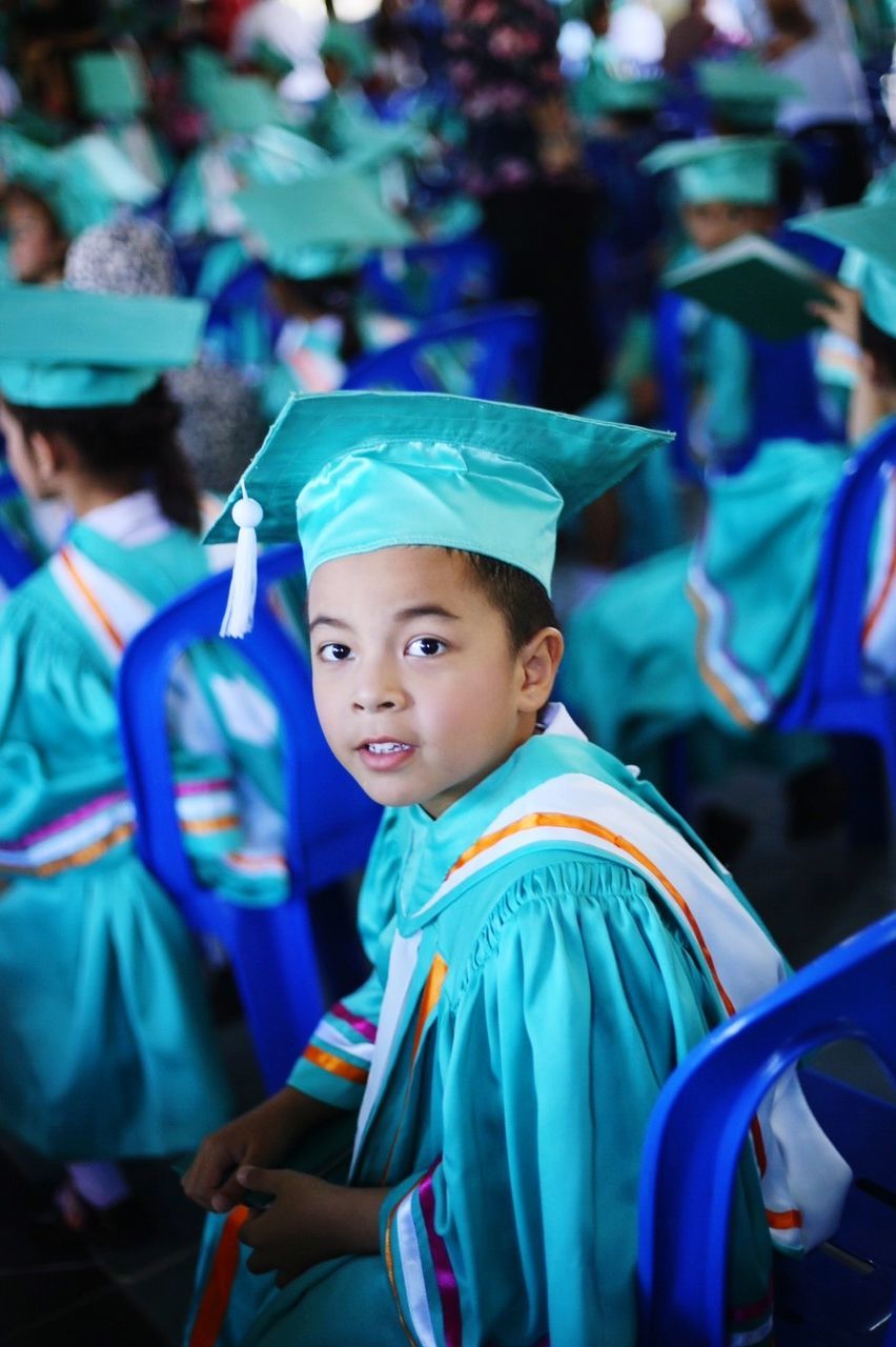 Portrait of boy wearing graduation gown