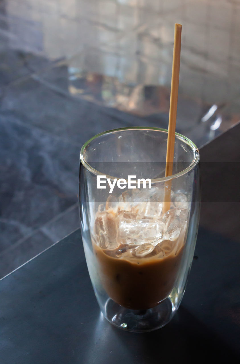 CLOSE-UP OF COFFEE IN GLASS