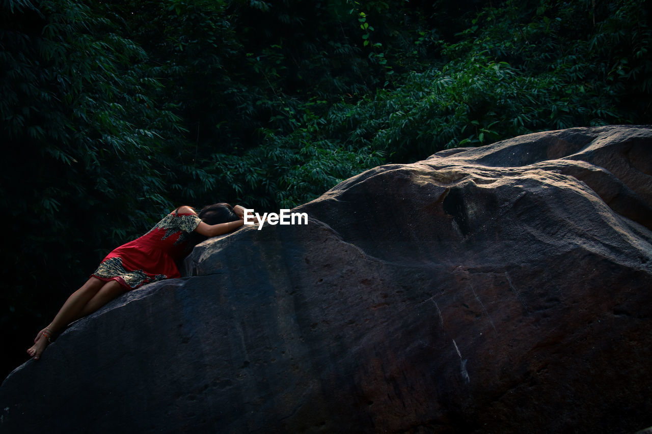 Woman on rock in forest