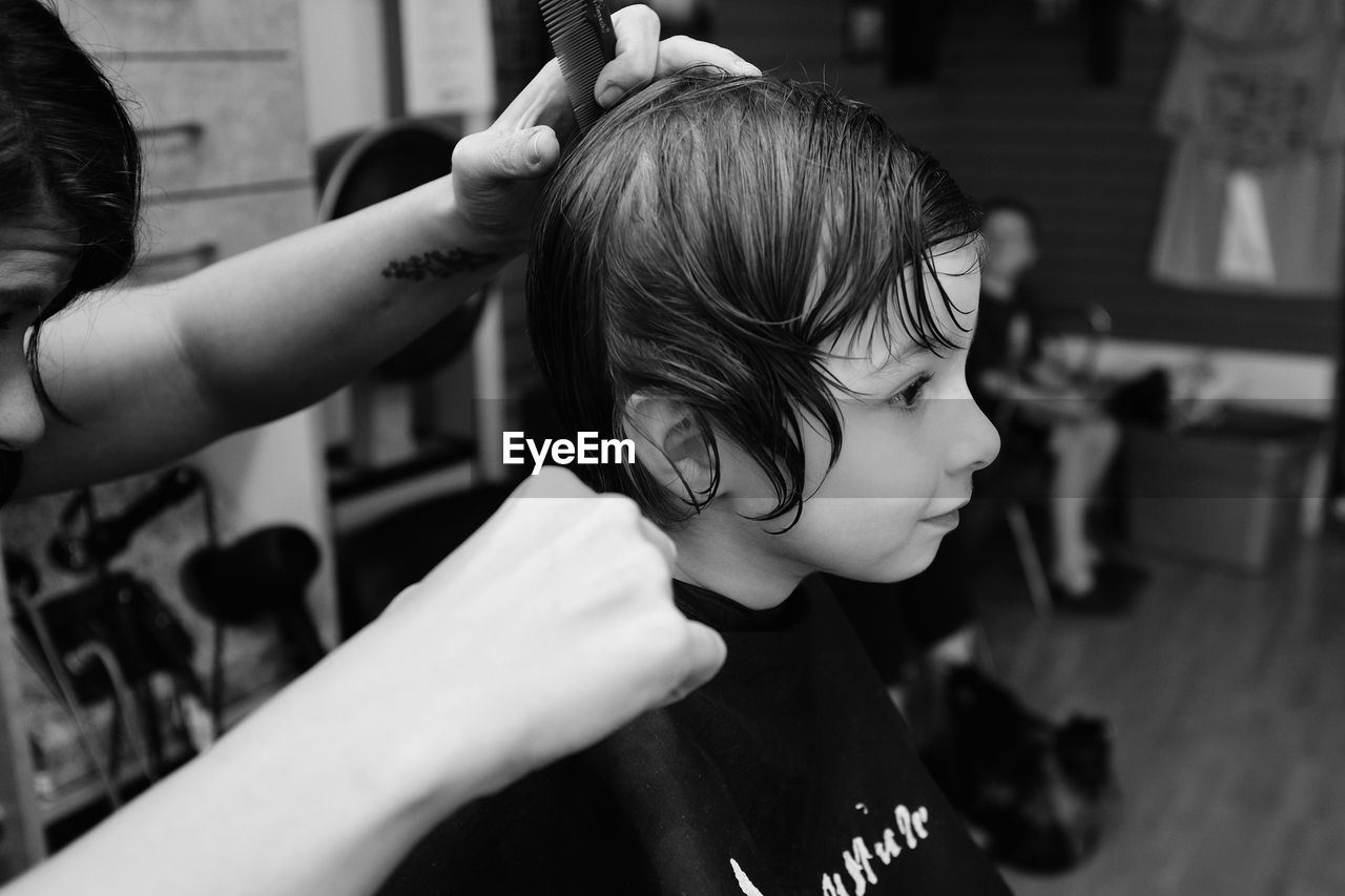 Close-up of girl getting a hair cut