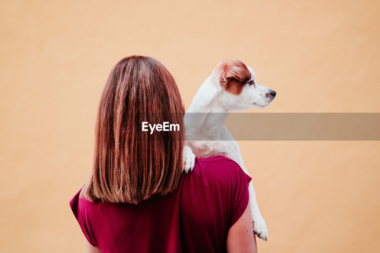 Rear view of woman with dog